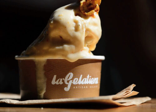Authentic artisan gelato slowly melting in a La Gelatiera cup, demonstrating its naturally creamy texture and warmer serving temperature.